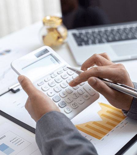 Close-up of a person using a calculator on financial documents